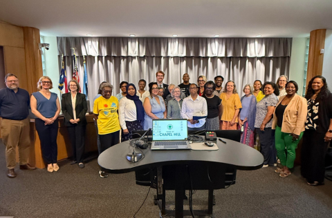 Council members and community members presenting and receiving resolution honoring Mae MacClendon