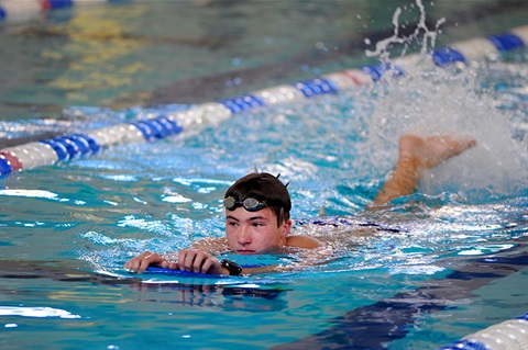 child swimming in pool